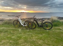 Two bikes in front of the East Lothian coastline at sunset